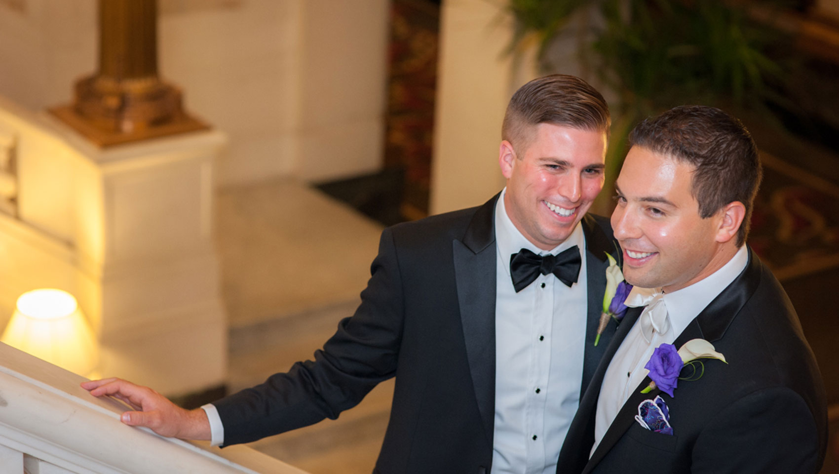 Grooms smiling at Hotel Monaco Baltimore