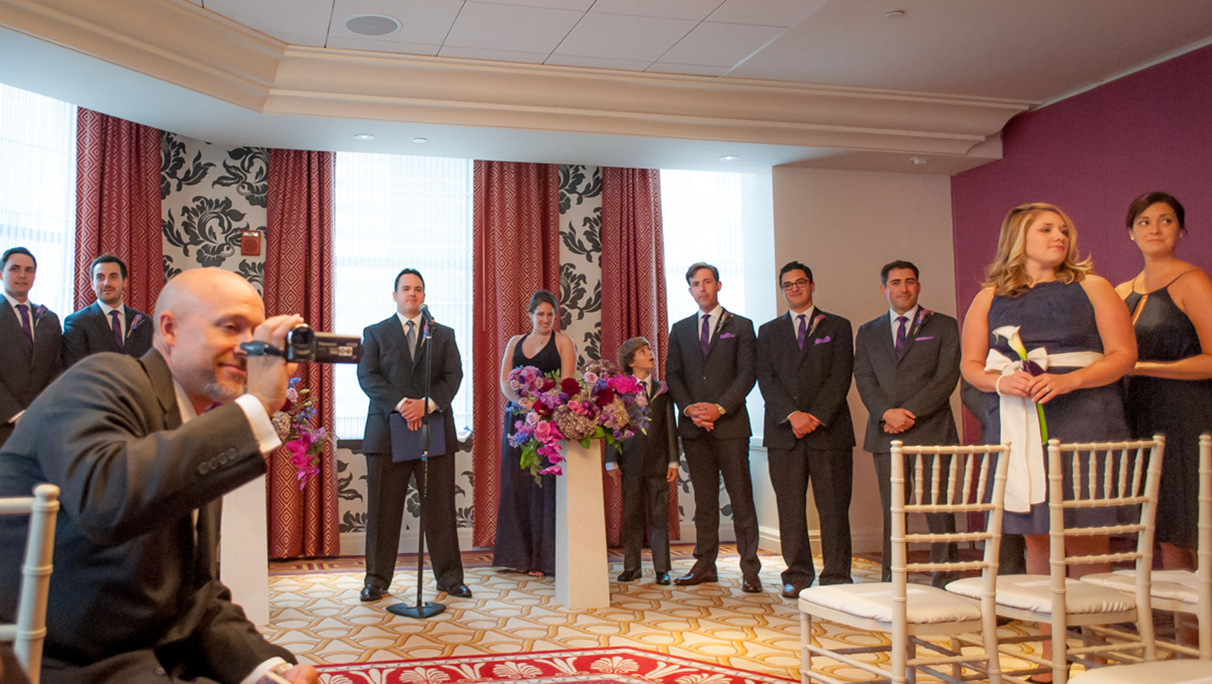 Groomsmen and Birdesmaids stand up at ceremony at Hotel Monaco Baltimore
