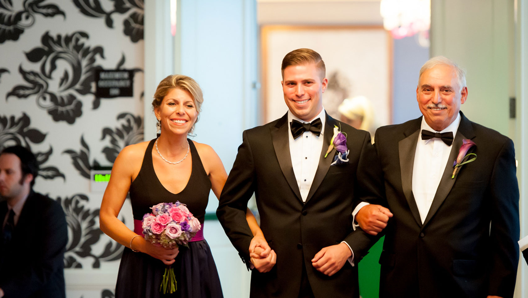 Groom walks down the aisle with his parents at Hotel Monaco Baltimore