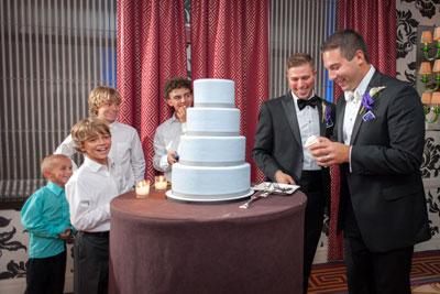 Grooms cutting Wedding Cake
